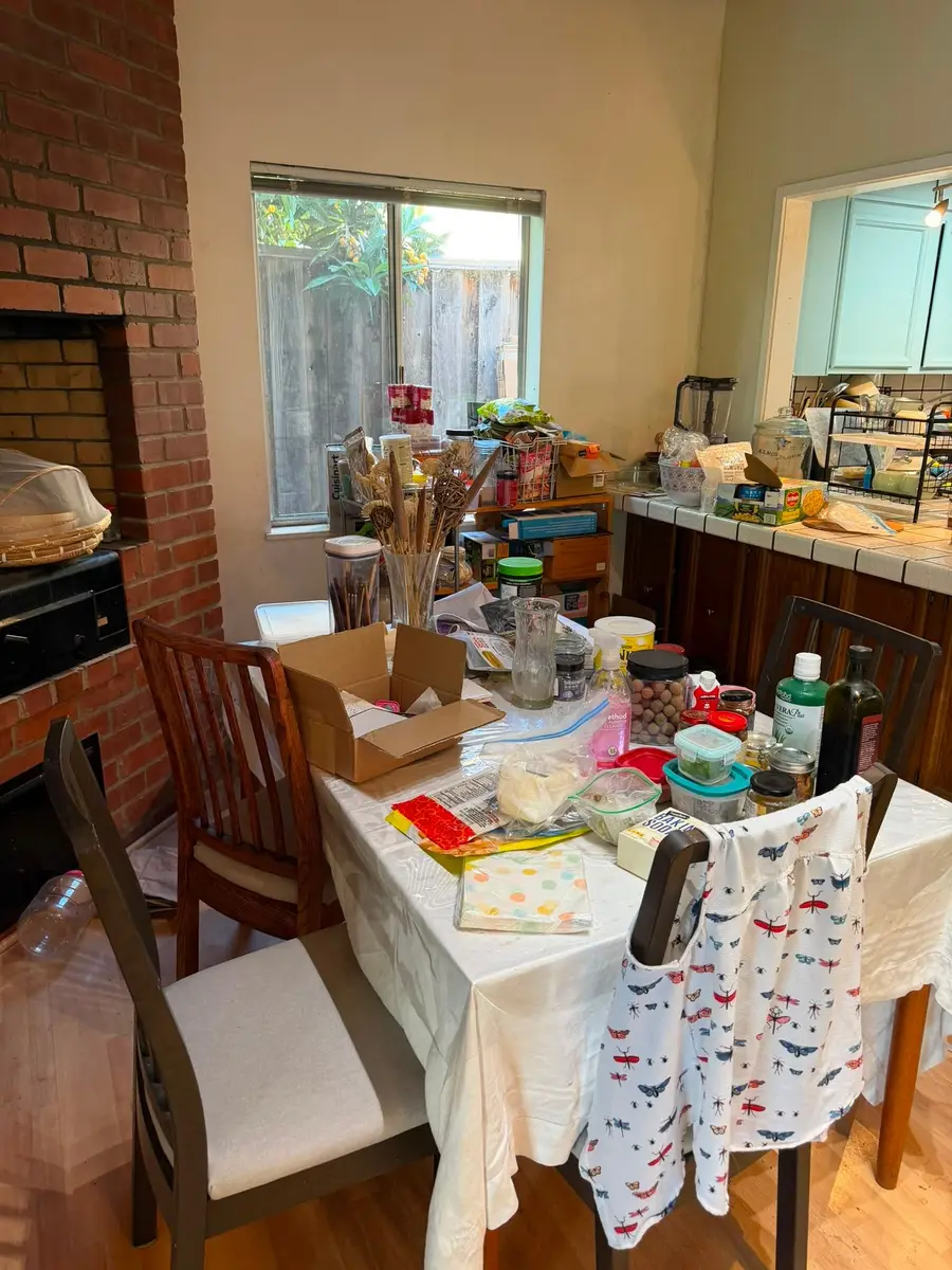 Before: dining table covered with groceries, boxes and kitchen supplies
